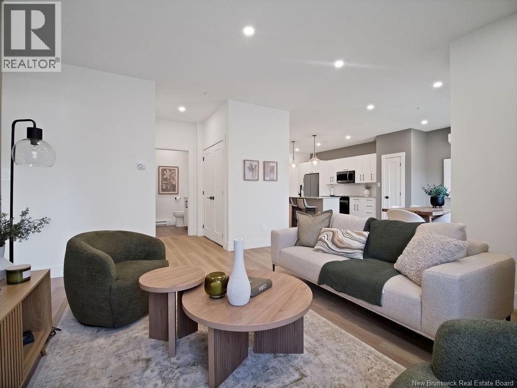 A modern living room with a grey couch and a wooden coffee table.