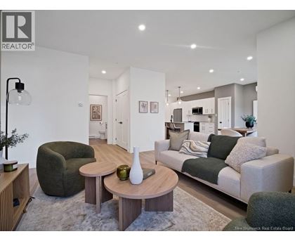 A modern living room with a grey couch and a wooden coffee table.
