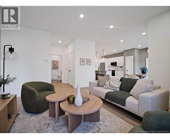 A modern living room with a grey couch and a wooden coffee table.
