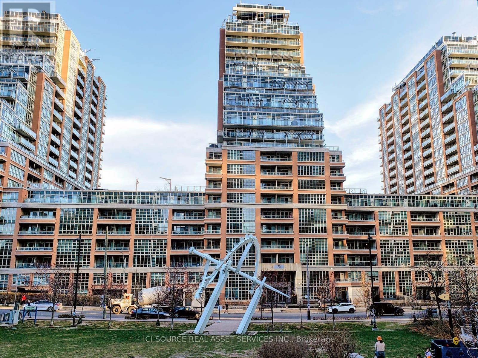 A large building with a lot of windows and a sculpture in front of it.