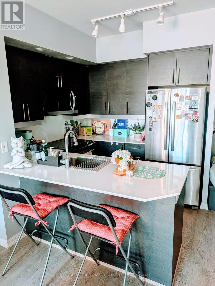 A kitchen with a white countertop and a refrigerator with magnets on it.