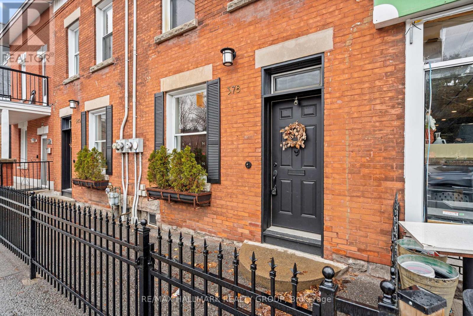 A black door with a wreath on it.