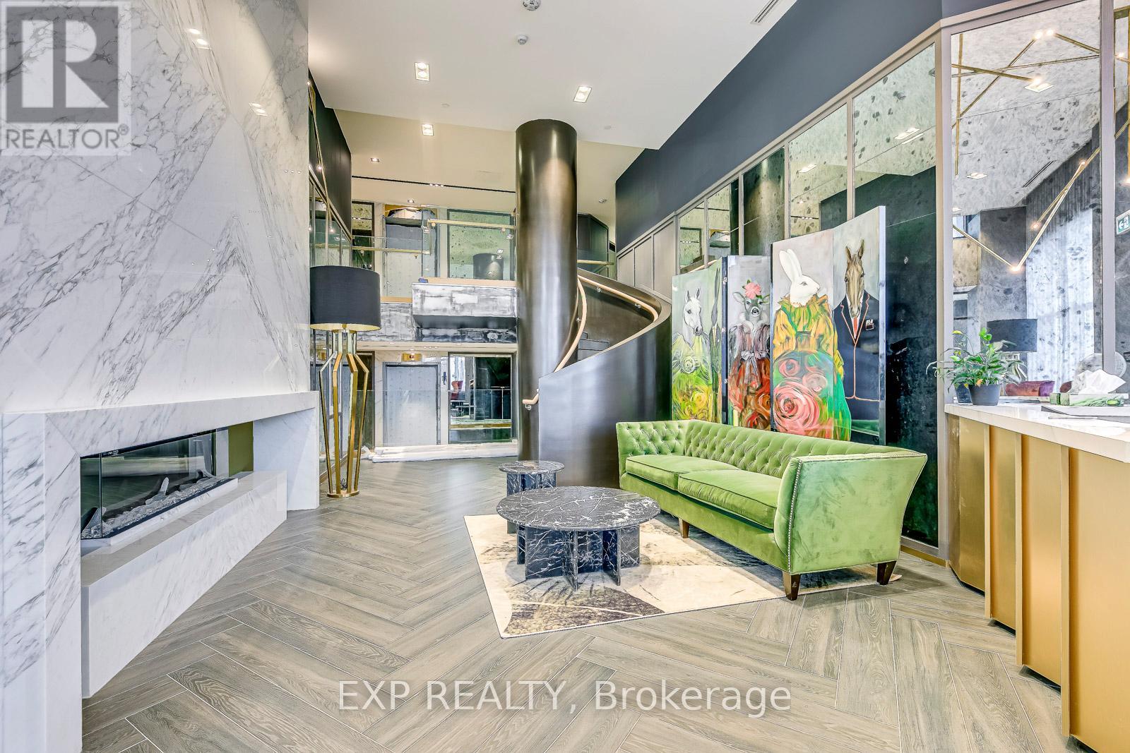 A modern living room with a green sofa and a fireplace.