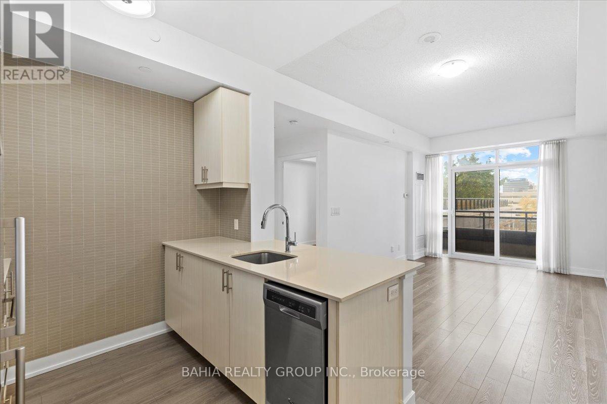 A kitchen with a sink and cabinets is shown in this image.