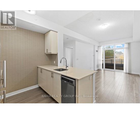A kitchen with a sink and cabinets is shown in this image.