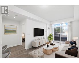 A living room with a flat screen TV mounted on the wall.