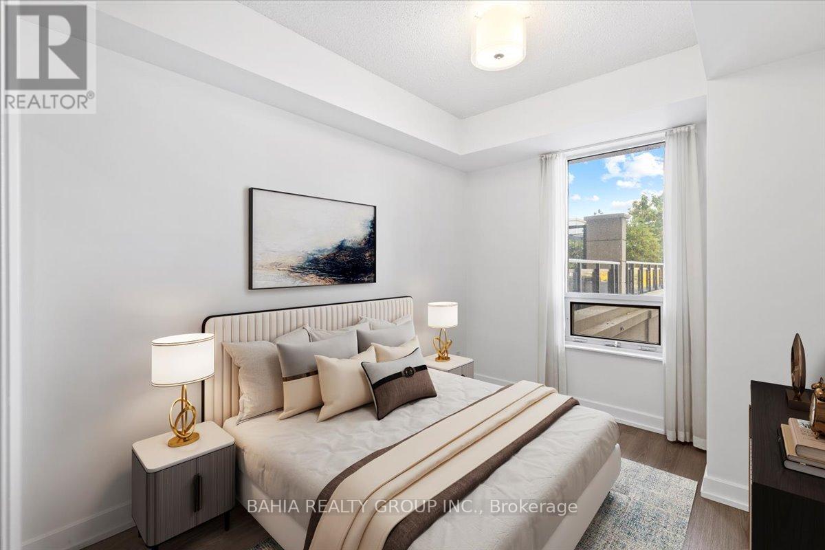 A well-lit bedroom with a large bed and a painting on the wall.