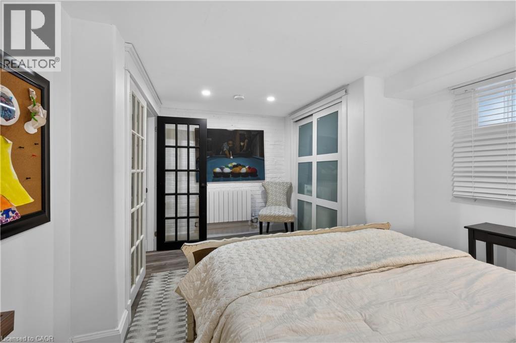 A bedroom with a large bed and a chair in the corner.
