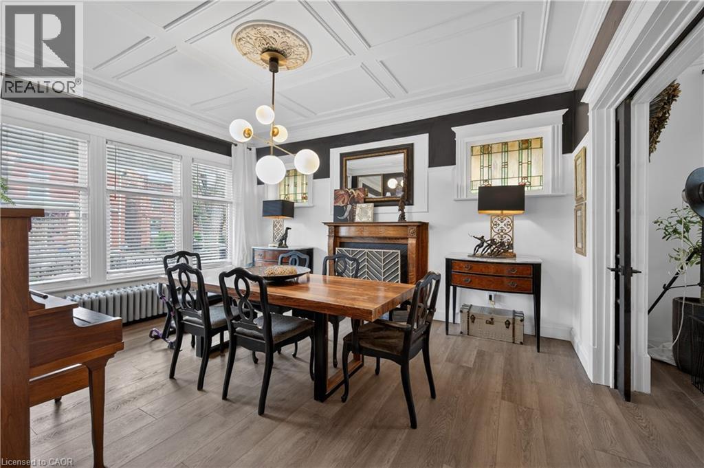 A dining room with a wooden table and chairs.