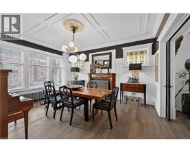 A dining room with a wooden table and chairs.