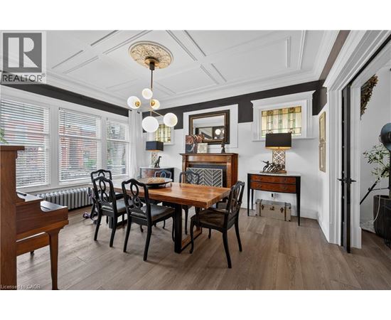 A dining room with a wooden table and chairs.