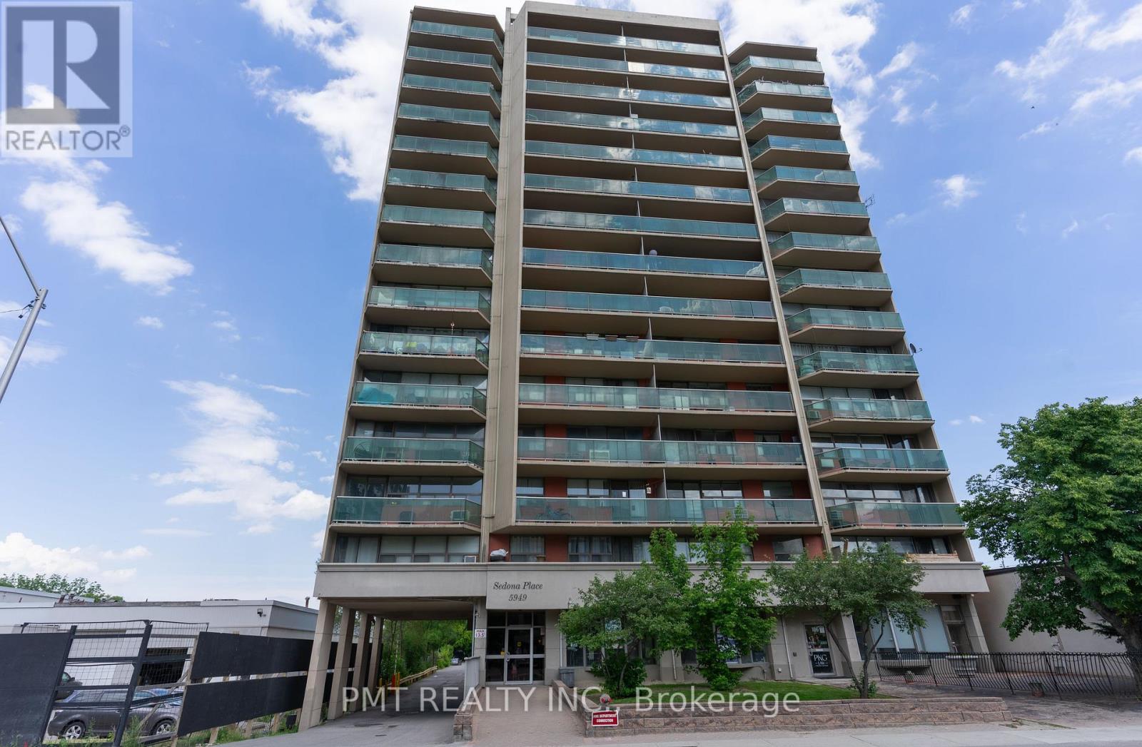 A tall residential building with balconies on each floor.