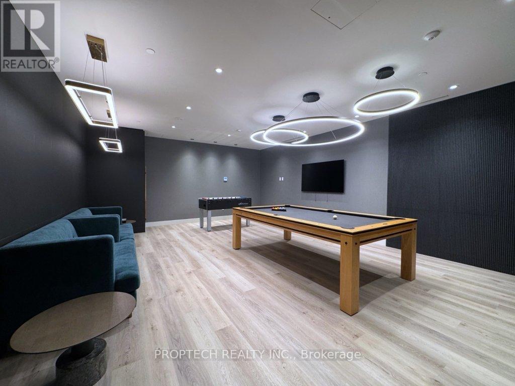 A room with a pool table and a couch.