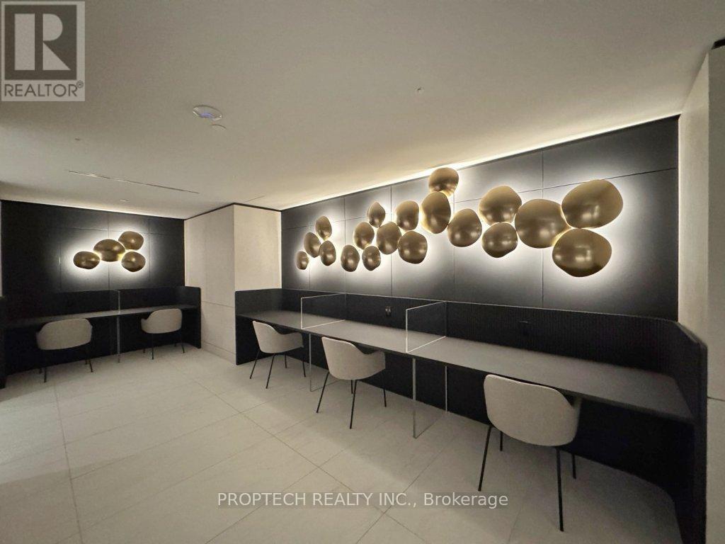 A modern dining area with a long table and chairs.