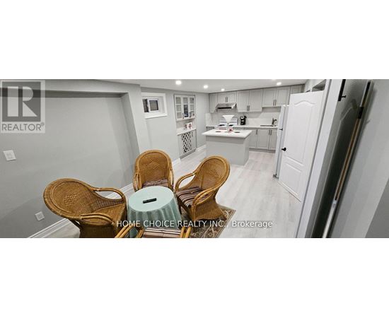 A kitchen with a dining table and chairs.