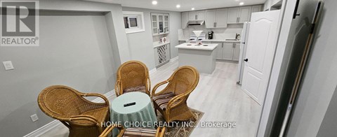A kitchen with a dining table and chairs.