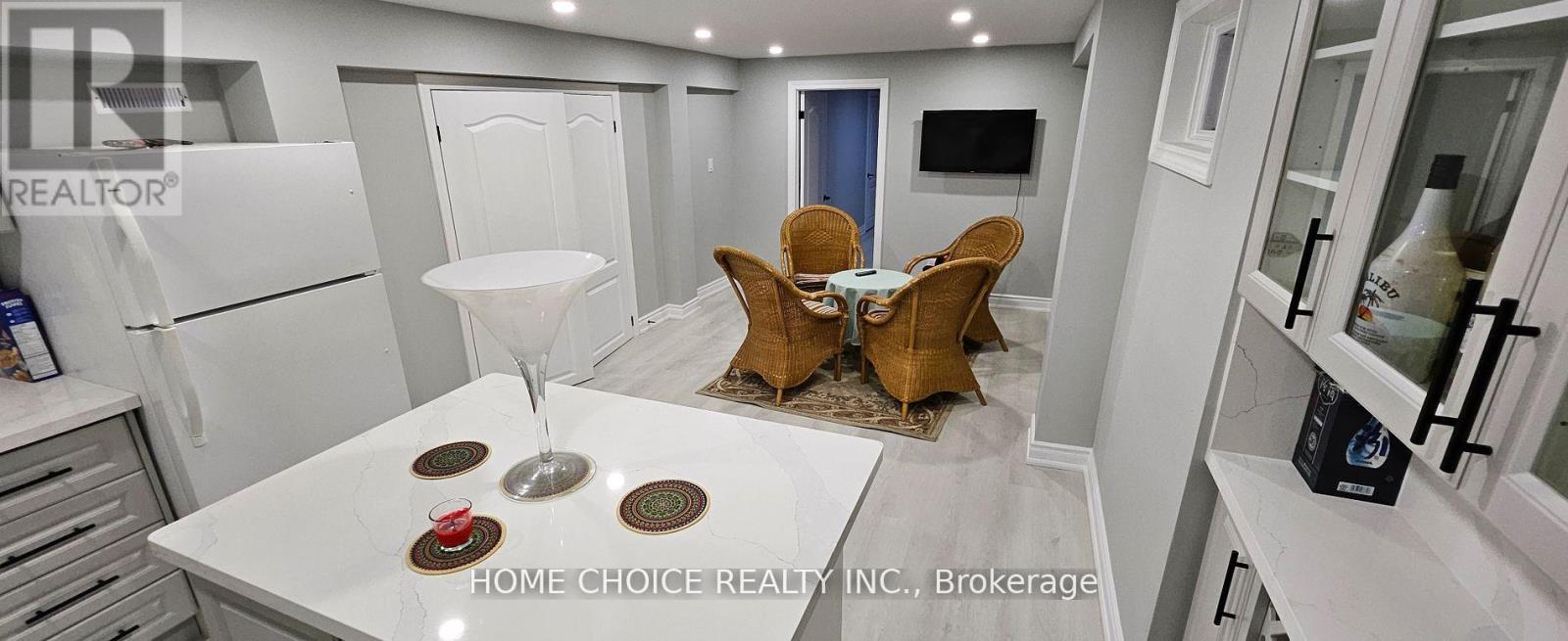 A modern kitchen with a dining table set for two.