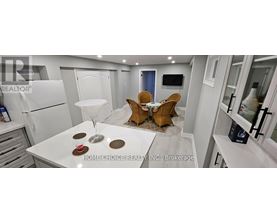 A modern kitchen with a dining table set for two.