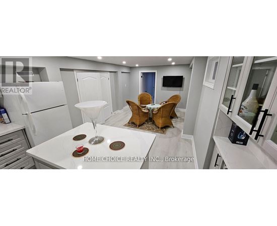 A modern kitchen with a dining table set for two.