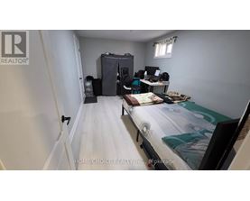 A bedroom with a bed, desk, and chair.