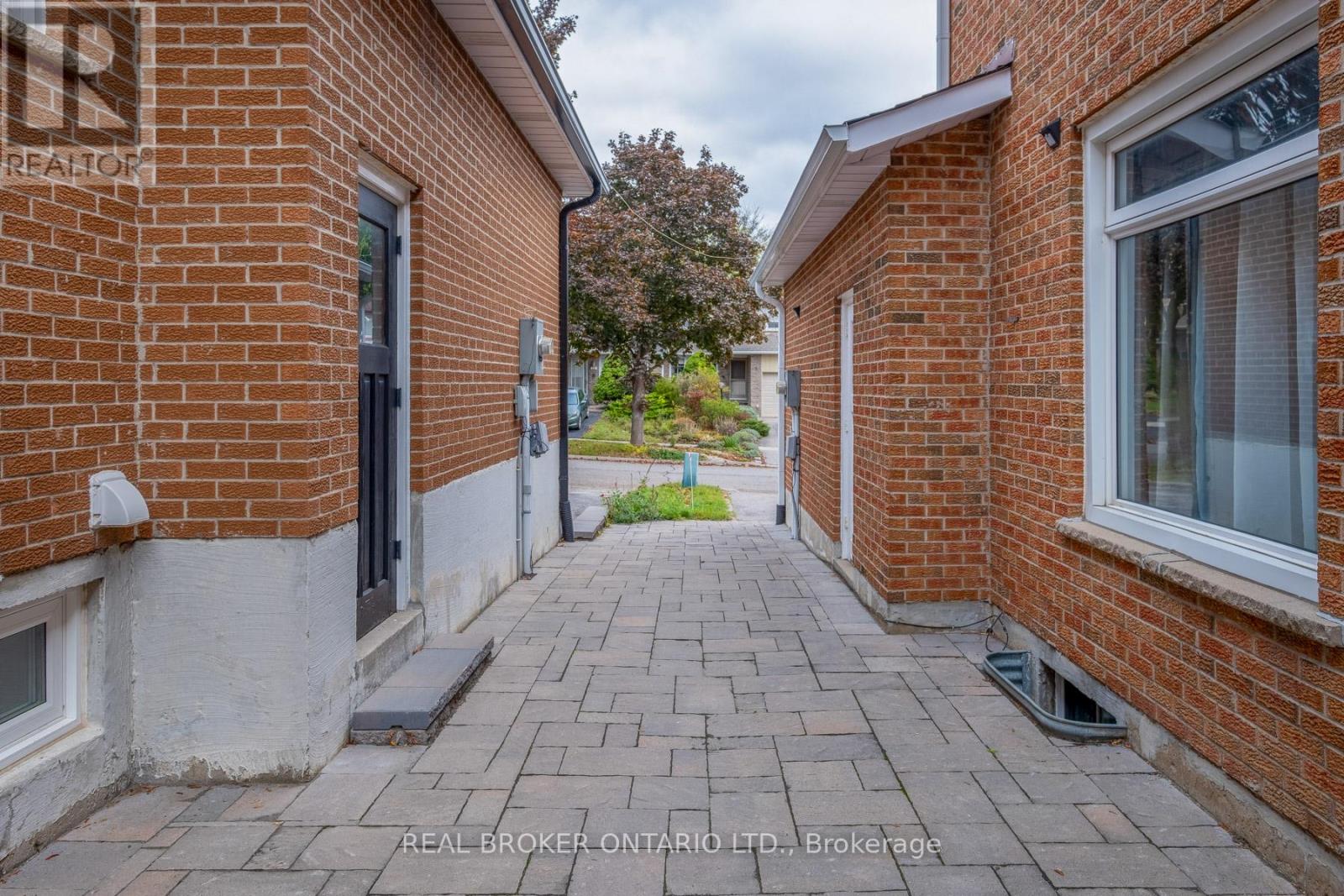 A brick building with a walkway in front.