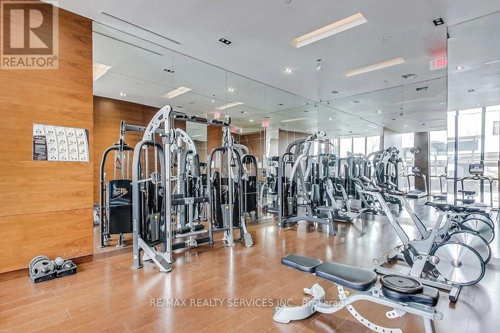 A gym with a variety of equipment including treadmills, weights, and exercise bikes.