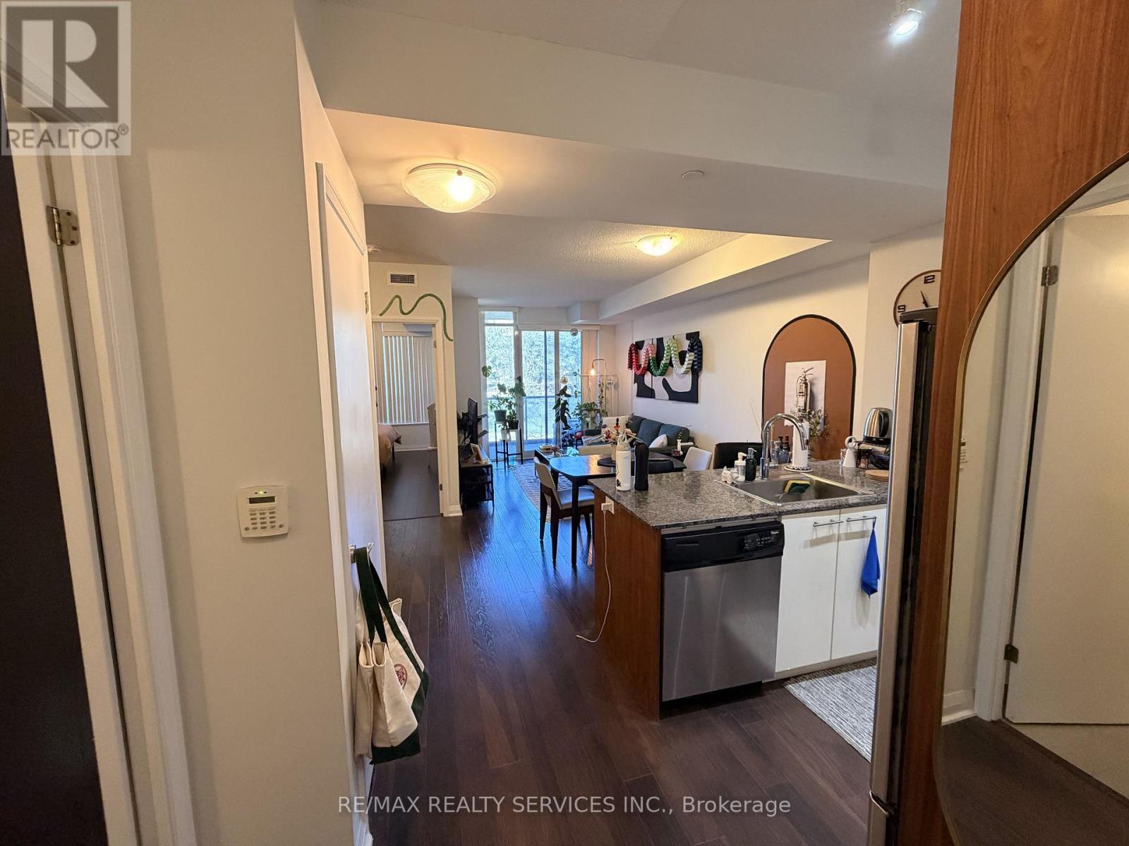 A kitchen with a dishwasher and a refrigerator.