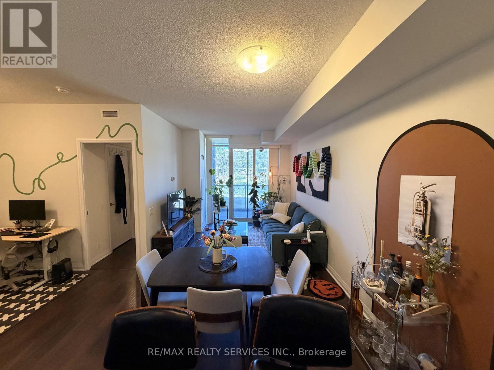 A living room with a dining table and chairs.