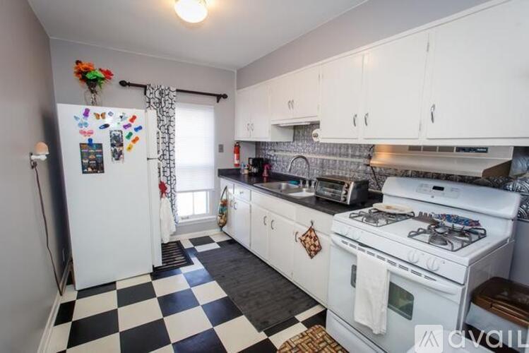A kitchen with black and white checkered floor.