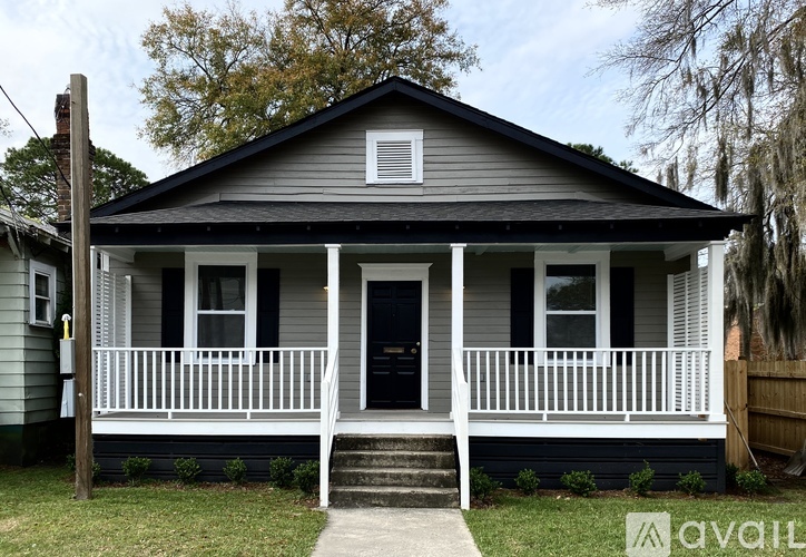 A small house with a porch and a front door.