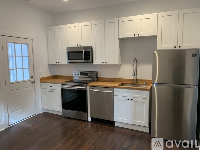 A kitchen with white cabinets and stainless steel appliances.