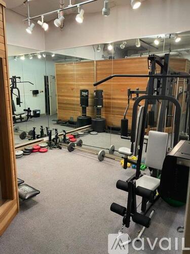A gym with a variety of equipment including weights and machines.