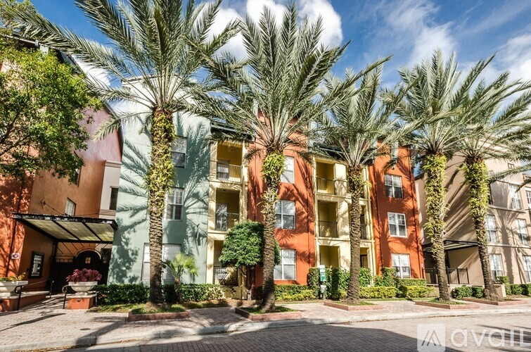 A row of palm trees in front of a building.