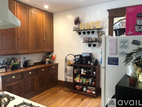 A kitchen with wooden cabinets and a white fridge.