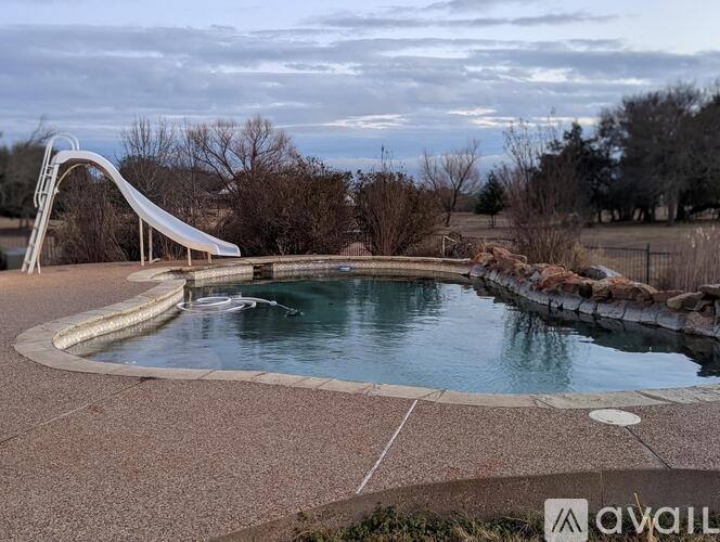 A pool with a slide in the middle of it.