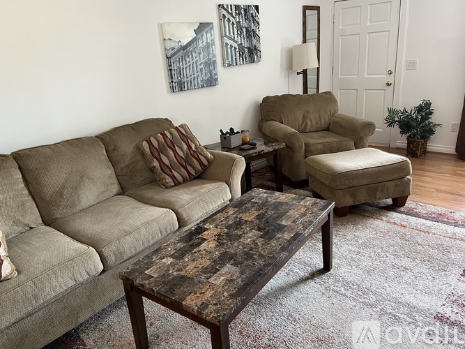 A living room with a couch, chair, and coffee table.