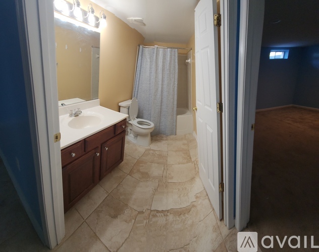 A bathroom with a toilet, sink, and shower.