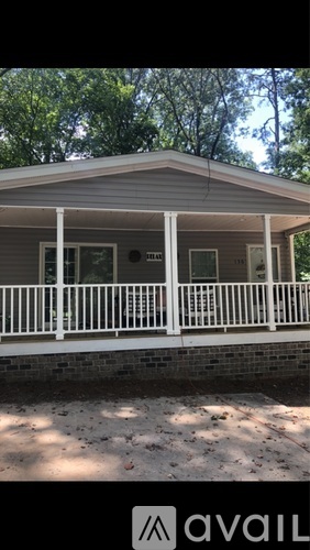 A house with a porch and a white railing.