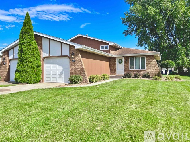 A house with a brown roof and a white garage door.