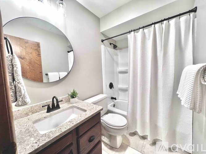 A bathroom with a sink, toilet, and shower.