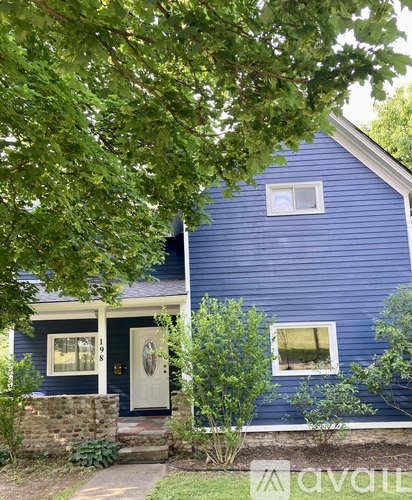 A blue house with a white door and windows.