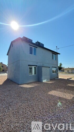 A house with a gravel driveway is for sale.