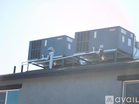 Two air conditioning units on a building.