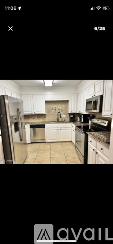 A kitchen with white cabinets and appliances.