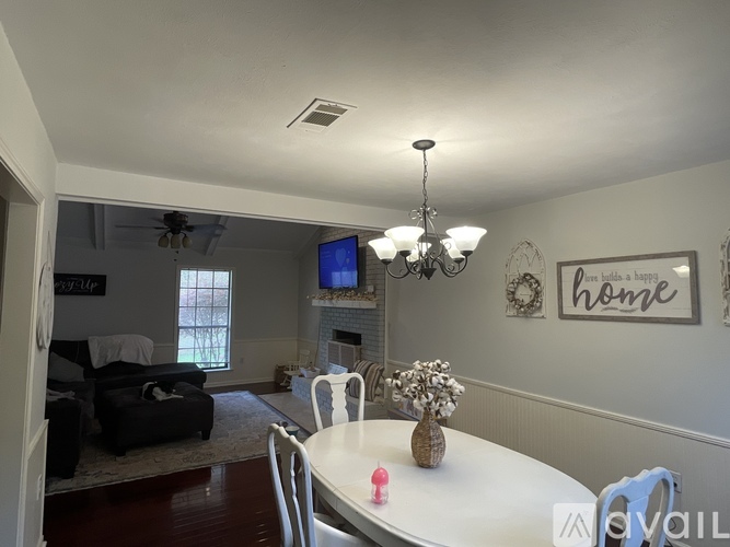 A living room with a fireplace and a television.