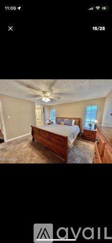 A bedroom with a bed, dresser, and mirror.