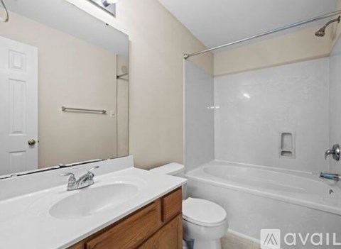 A bathroom with a white sink, toilet, and bathtub.
