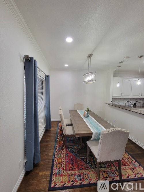 A dining room with a long table and chairs.