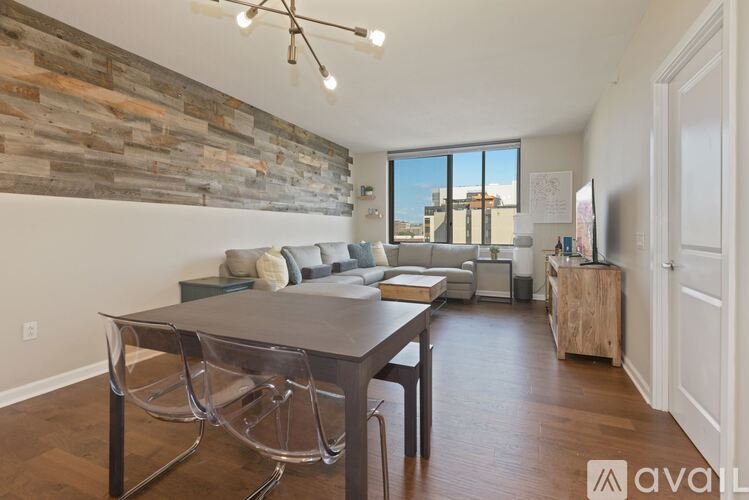 A dining room with a wooden table and chairs.