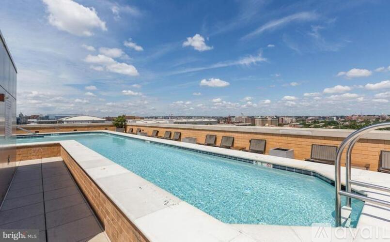 A swimming pool on a rooftop with a city view.